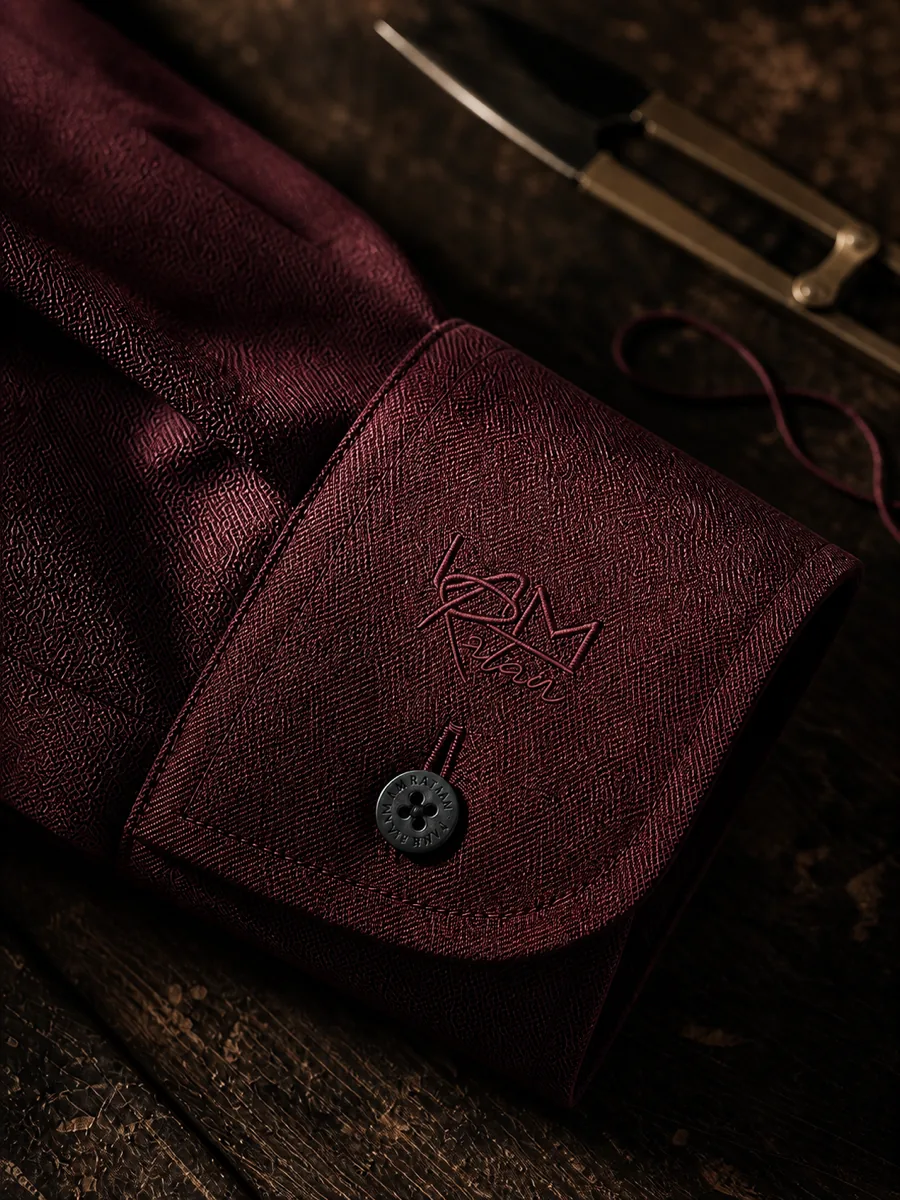 A claret cuff and its pearl button in close macro